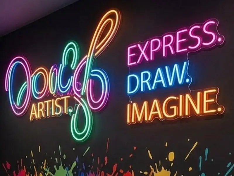 Neon wall signs reading 'Express. Draw. Imagine.'