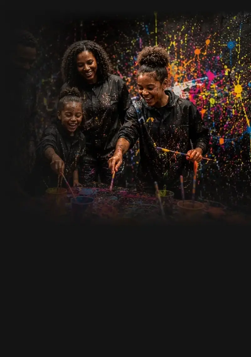 A family laughing while painting together